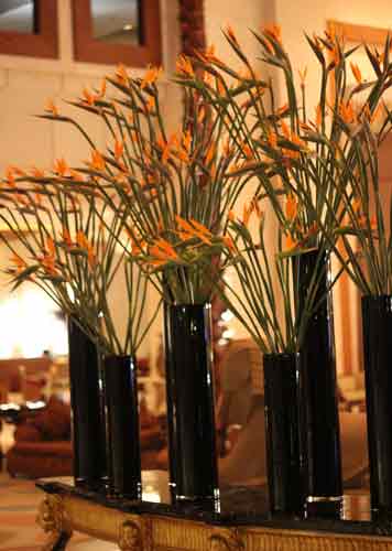vase of bird flowers on table