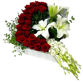 A flower box of red roses with white lilies and orchids