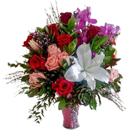 A flower vase with red and white roses and lilies with green leaves