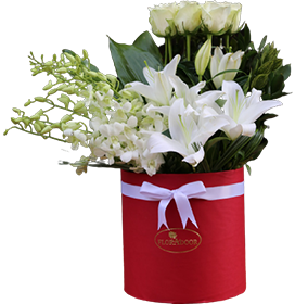 A flower box of white roses with baby orchids and lilies