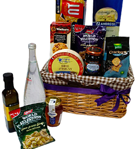 A gift basket of honey, cheese and snacks of different brands