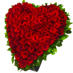 A heart-shaped flower bouquet with red roses and ruscus greenery