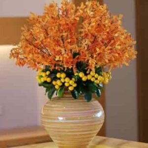 vase of orange flowers on table