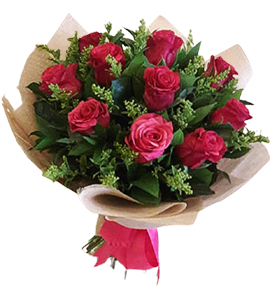 A flower bouquet of fuchsia roses with green leaves and beige wrapping