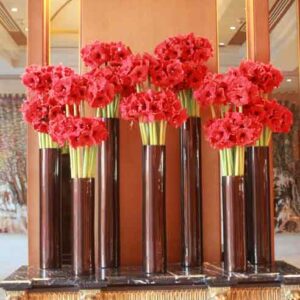 vase of red flowers on table
