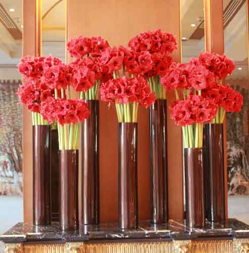 vase of red flowers on table