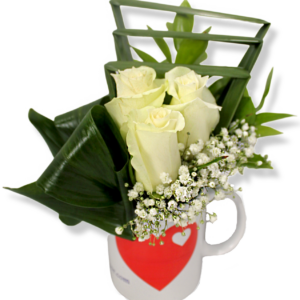 A love mug with 3 white roses, baby flowers and green leaves