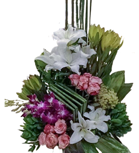 A large flower arrangement with pink roses, white lilies, and orchids with green leaves