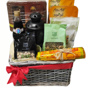 A gift basket containing Ramadan sweets and snacks with a Ramadan lantern