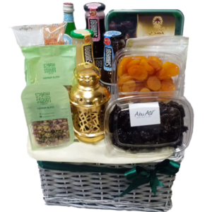 A gift basket containing Ramadan sweets and snacks with a Ramadan lantern