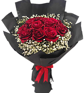 A flower bouquet of red roses with white baby flowers