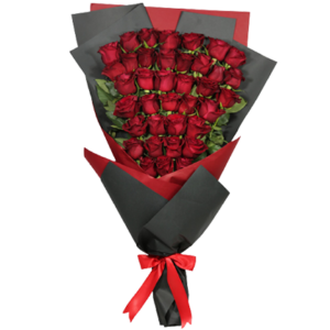A bouquet of long red roses wrapped in black and red