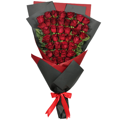 A bouquet of long red roses wrapped in black and red