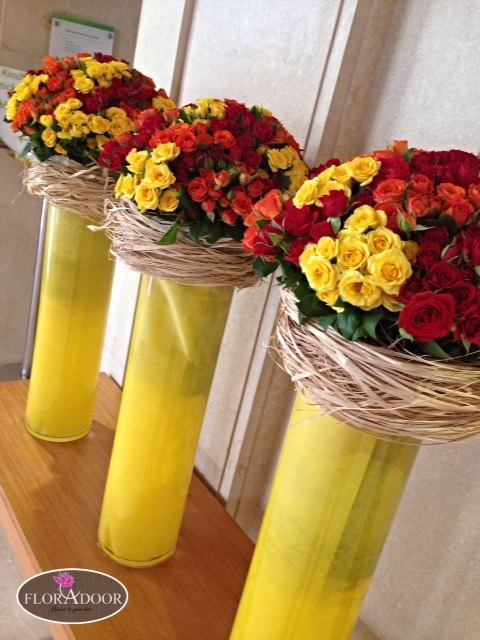 basket of yellow , red,orange flowers and greeny