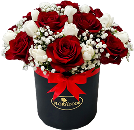 A flower box of red roses and white tulips