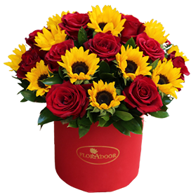 A flower box of red roses with sunflowers and green leaves