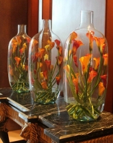 vase of orange calla on table