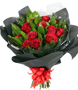 A flower bouquet with red roses and ruscus greenery, wrapped in black and tied with a big ribbon